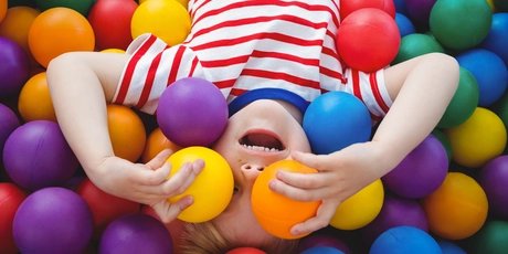 Cute smiling boy in sponge ball pool