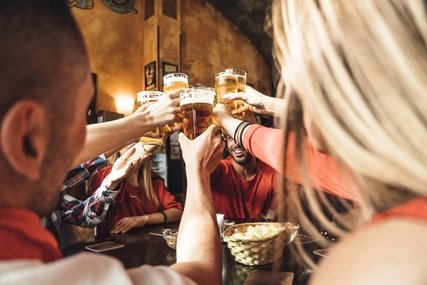 Group of happy friends drinking beer at the brewery