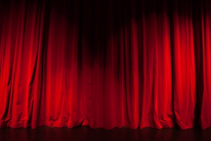 Curtain from the theatre with a spotlight as background
