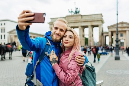 Stylish Young Couple Take A Selfie In Front Of Local Architecture