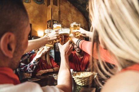 Group of happy friends drinking beer at the brewery