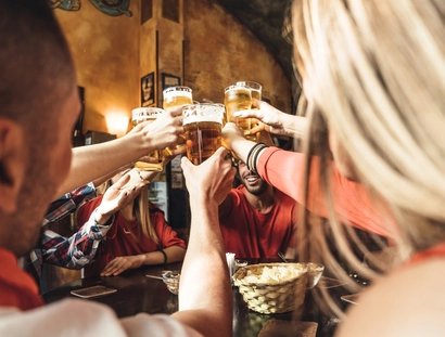 Group of happy friends drinking beer at the brewery