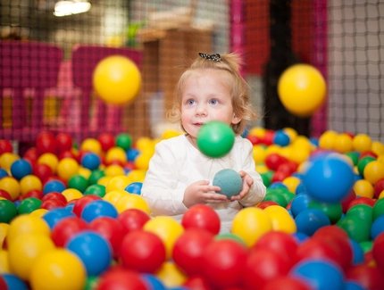 Baby girl in ball pool