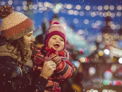 Mutter und Baby auf dem Weihnachtsmarkt