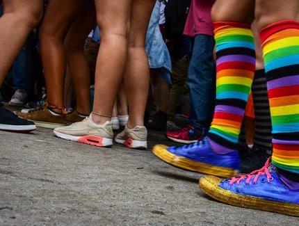 Person mit Regenbogensocken in Menschenmenge in Berlin