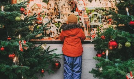 Little boy  standing near Christmas tree in Rothenburg